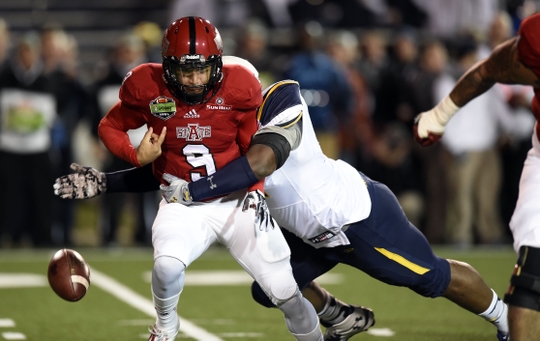 Jan 4, 2015; Mobile, AL, USA; Toledo Rockets defensive tackle Treyvon Hester (91) knocks the ball away from Arkansas State Red Wolves quarterback Fredi Knighten (9) during the first quarter of the 2015 GoDaddy Bowl at Ladd-Peebles Stadium. Mandatory Credit: John David Mercer-USA TODAY Sports