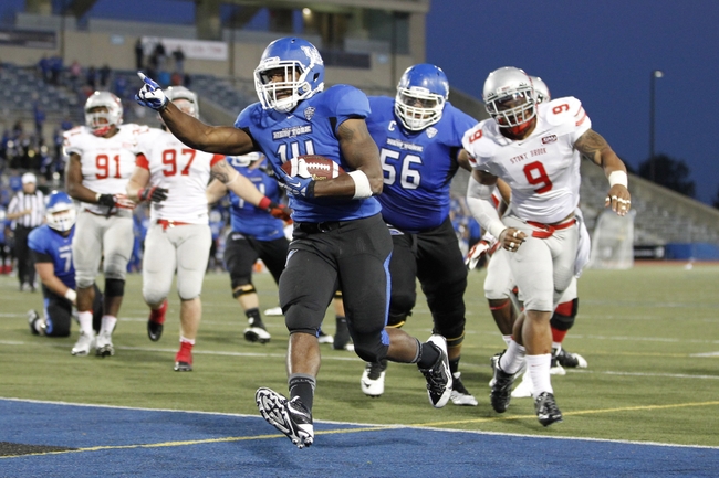 Sep 14, 2013; Buffalo, NY, USA; Buffalo Bulls running back Anthone Taylor (14) runs for the winning touchdown in OT against the Stony Brook Seawolves at University of Buffalo Stadium. Buffalo beats Stony Brook 26-23 in OT. Mandatory Credit: Kevin Hoffman-USA TODAY Sports