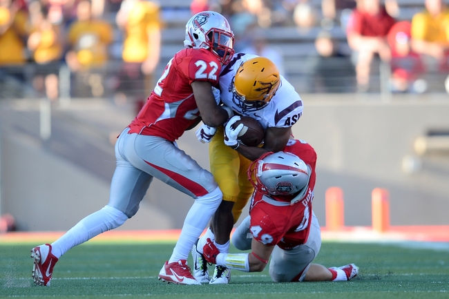 Sep 6, 2014; Albuquerque, NM, USA; New Mexico Lobos defensive back Markel Byrd (22) and New Mexico Lobos linebacker Dakota Cox (49) tackle Arizona State Sun Devils wide receiver Cameron Smith (6) at University Stadium. Arizona State won 58-23 Mandatory Credit: Joe Camporeale-USA TODAY Sports