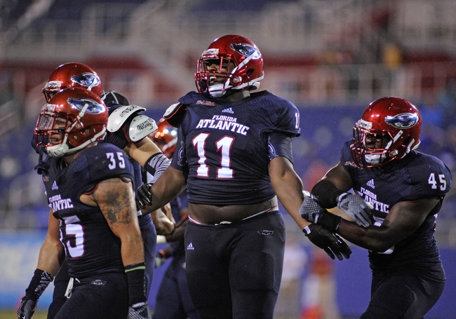 Sep 13, 2014; Boca Raton, FL, USA; Florida Atlantic Owls defensive lineman Trevon Coley (11) celebrates an interception as the Owls beat the Tulsa Golden Hurricane 50-21 at FAU Football Stadium. Mandatory Credit: David Manning-USA TODAY Sports