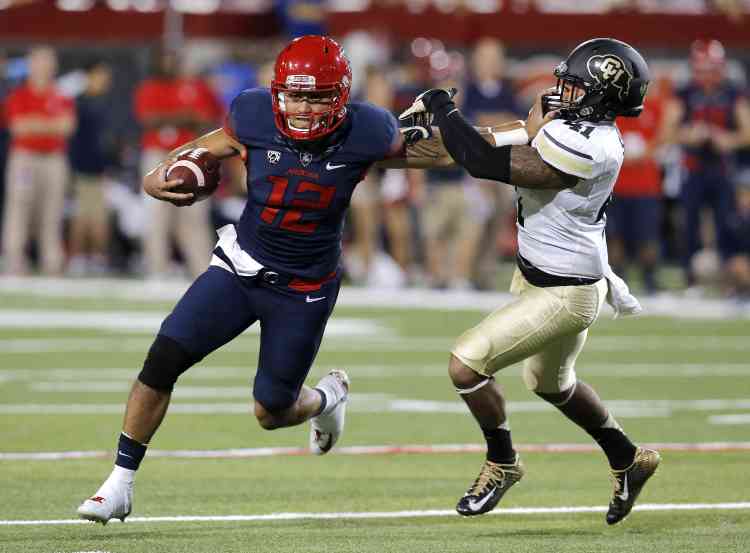 Zona QB Anu Solomon stiff arms a CU defender (Photo Courtesy of AP Photo)