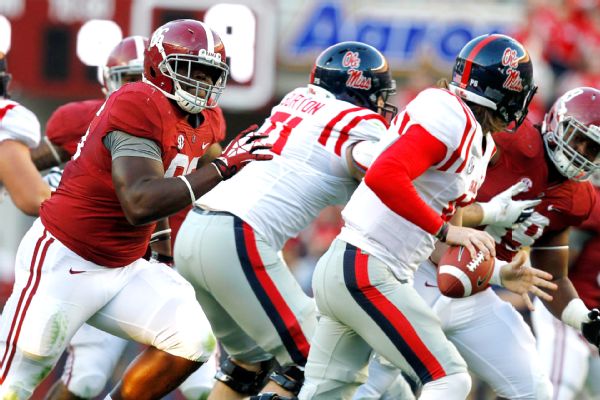 UA DL A'Shawn Robinson pressures Ole Miss QB Bo Wallace (Photo Courtesy of AP Photo/Butch Dill)