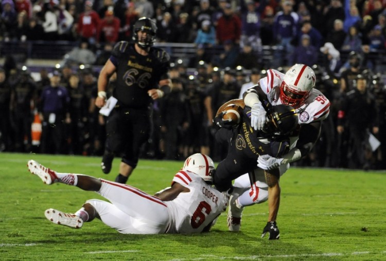 Oct 18, 2014; Evanston, IL, USA; Northwestern Wildcats wide receiver Tony Jones (6) is tackled by Nebraska Cornhuskers safety Corey Cooper (6) and defensive tackle Vincent Valentine (98) during the first half at Ryan Field. Mandatory Credit: David Banks-USA TODAY Sports