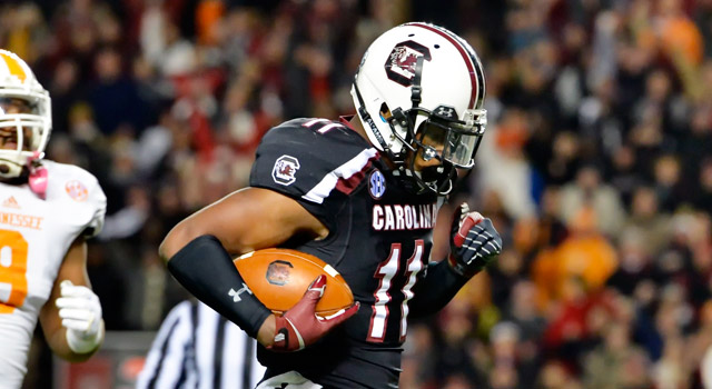South Carolina's Pharoh Cooper, right, runs in for a touchdown while pursued by Tennessee's Derek Barnett during the first half of an NCAA college football game in Columbia, S.C., Saturday, Nov. 1, 2014. (AP Photo/ Richard Shiro)
