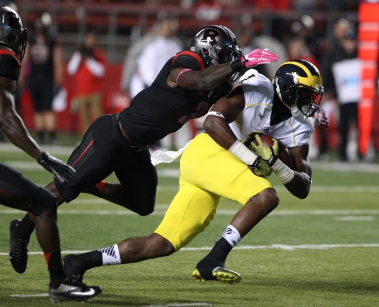 Oct 4, 2014; Piscataway, NJ, USA;   Rutgers Scarlet Knights linebacker Steve Longa (3) tackles Michigan Wolverines wide receiver Devin Funchess (1) during the first half at High Points Solutions Stadium. Mandatory Credit: Noah K. Murray-USA TODAY Sports