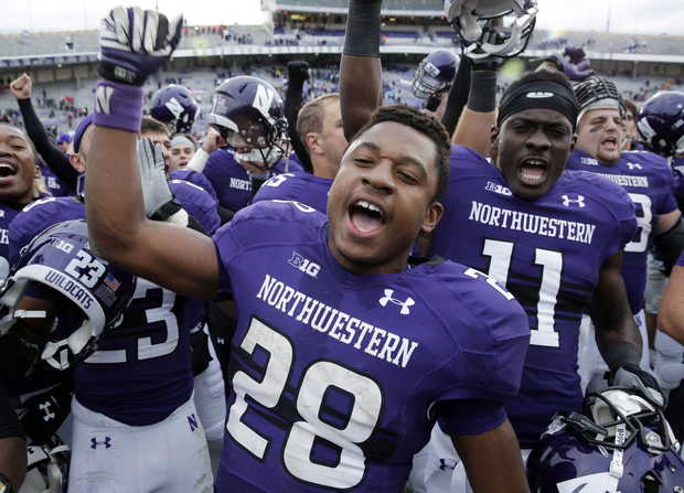 NW RB Justin Jackson and teammates celebrate a win over Stanford (Photo Courtesy of Nam Y. Huh/Associated Press)